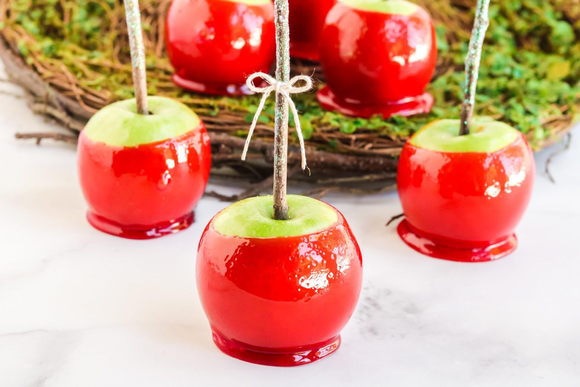 red candy apples on white counter top