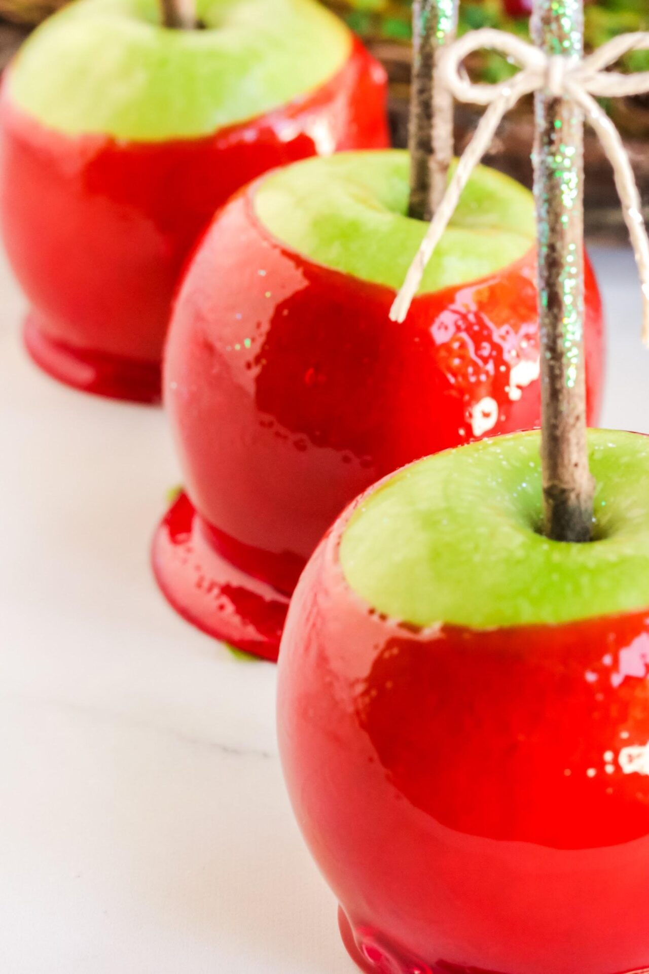 3 red candy apples lined up