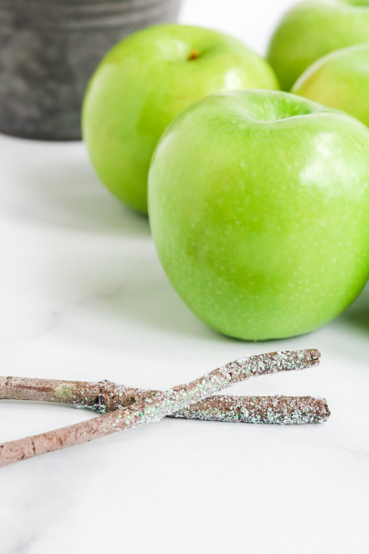 granny smith apples and wooden glitter sticks