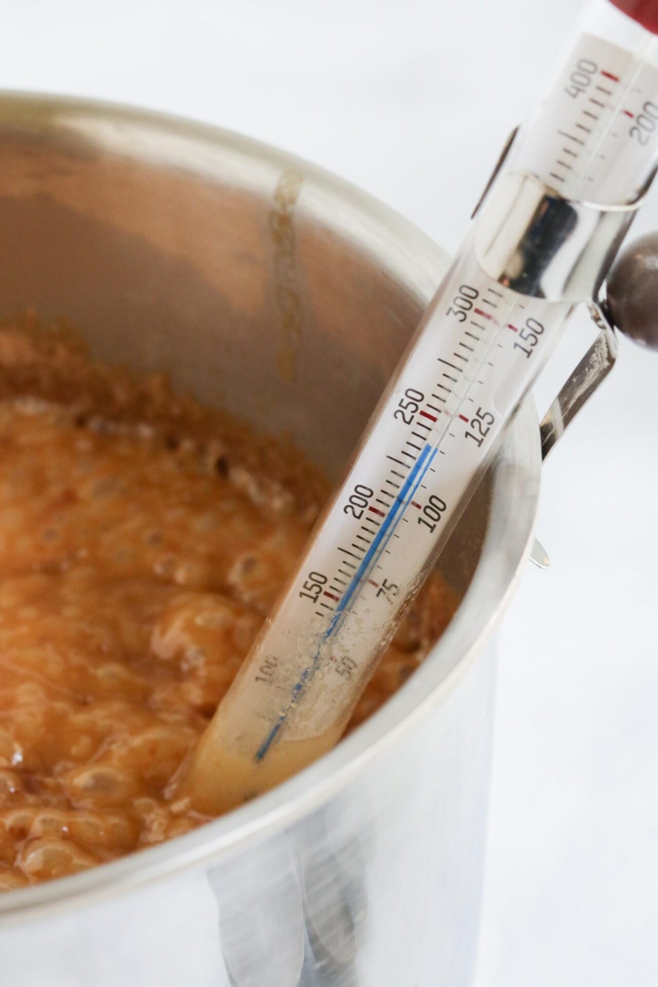 candy thermometer in caramel