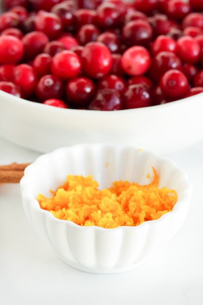 Cranberries in bowl with orange zest in bowl