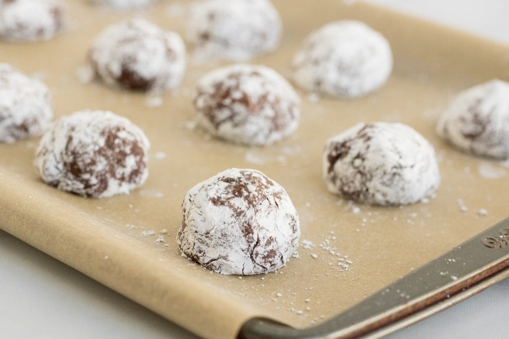 This Chocolate Crinkle Cookie recipe is fudgy almost brownie like inside with a delicious cracked outside. This is one of my favorite Christmas cookies!