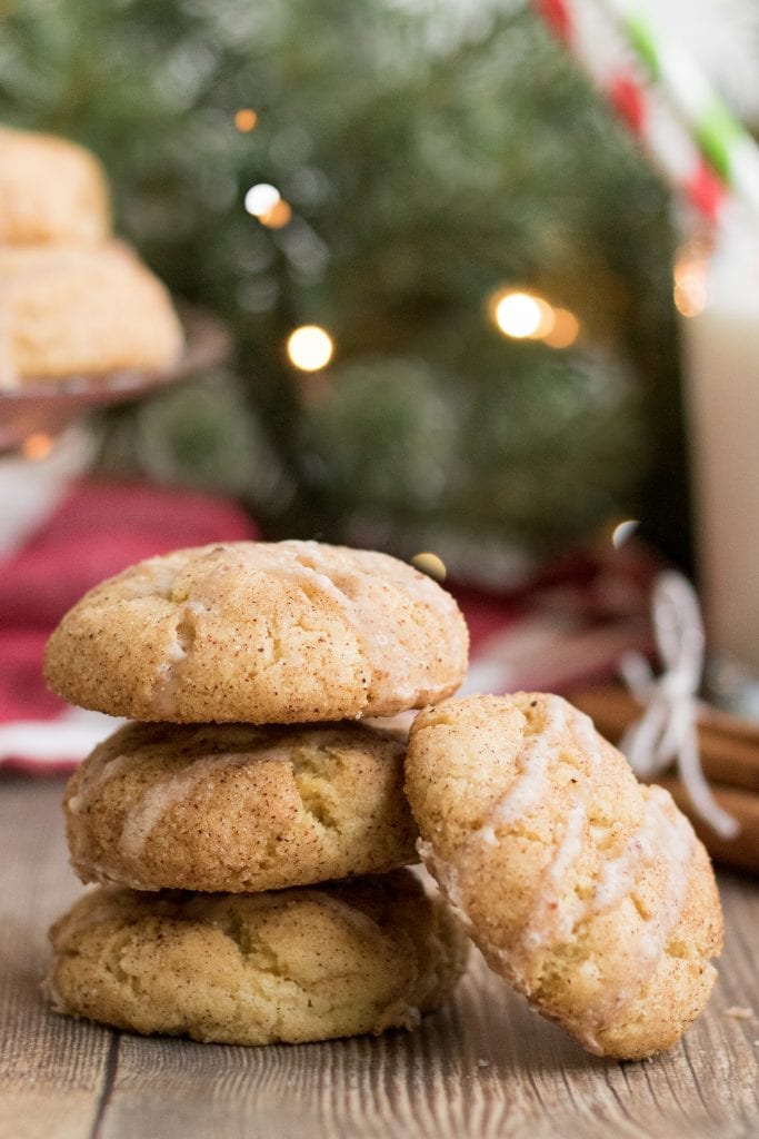 3 eggnog cookies stacked on top of one another with one laying on its side next to it. 