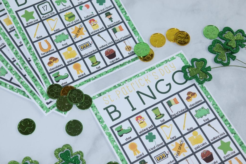 St. Patrick's Day Bingo sheets with play coins and shamrock decorations