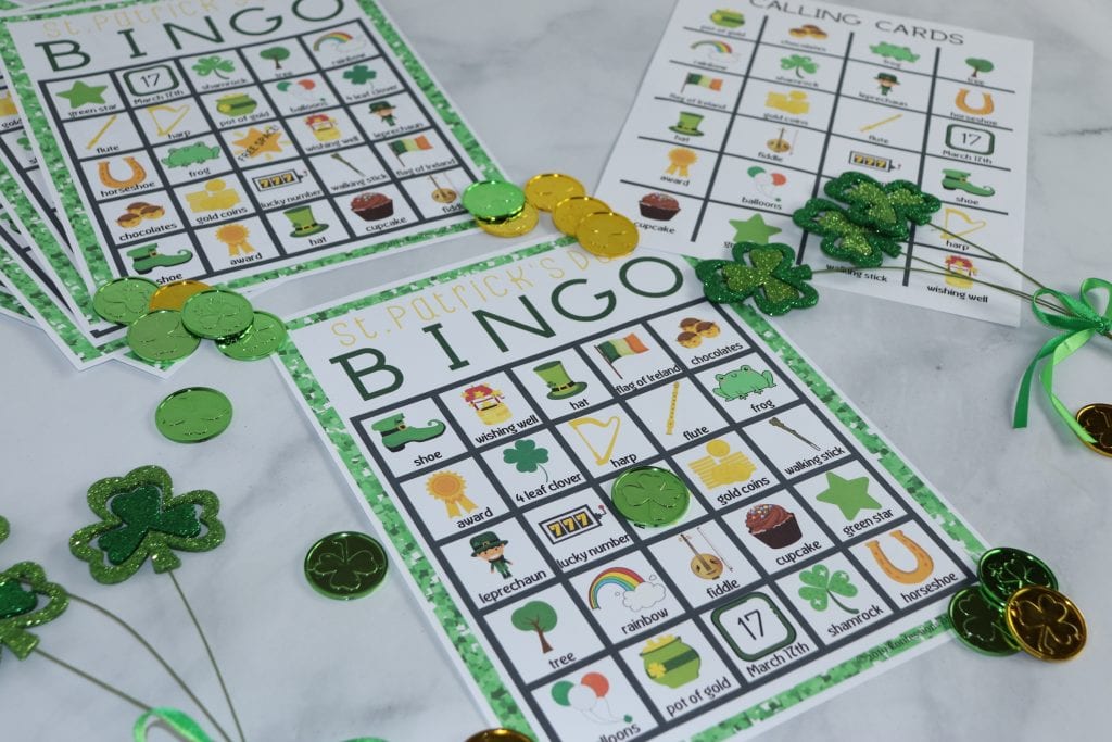 St. Patrick's Day Bingo sheets with play coins and shamrock decorations