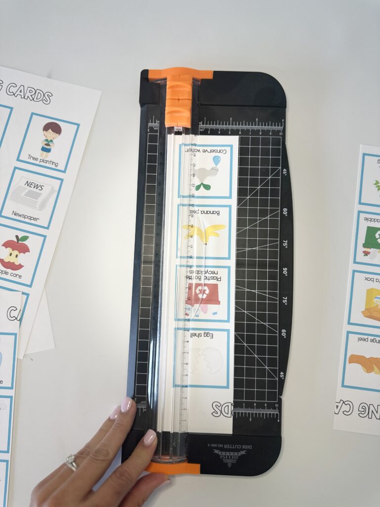 earth day calling cards being cut with paper cutter