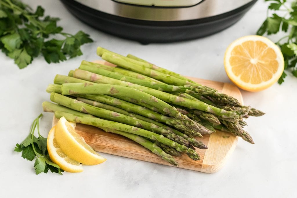 asparagus on cutting board with lemon