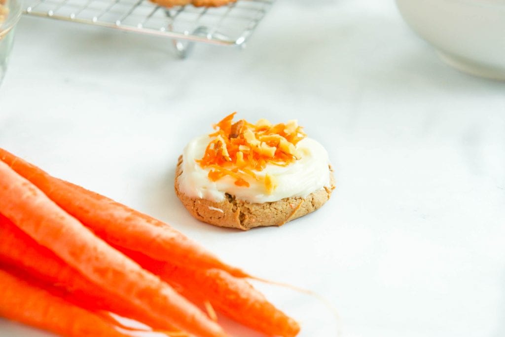 carrot cake mix cookie with shaved carrots and frosting on top