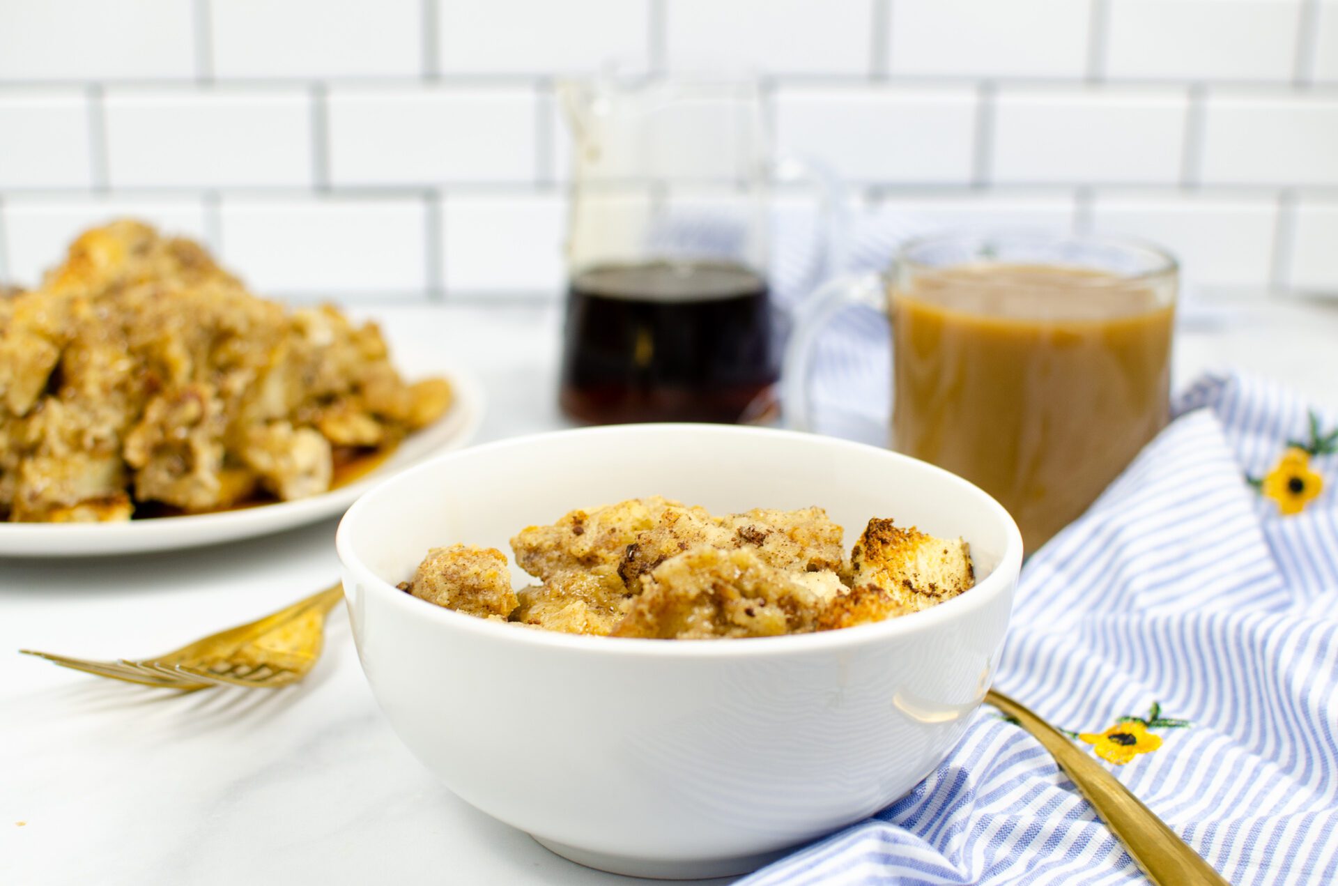 oven French toast in bowl with syrup in the back
