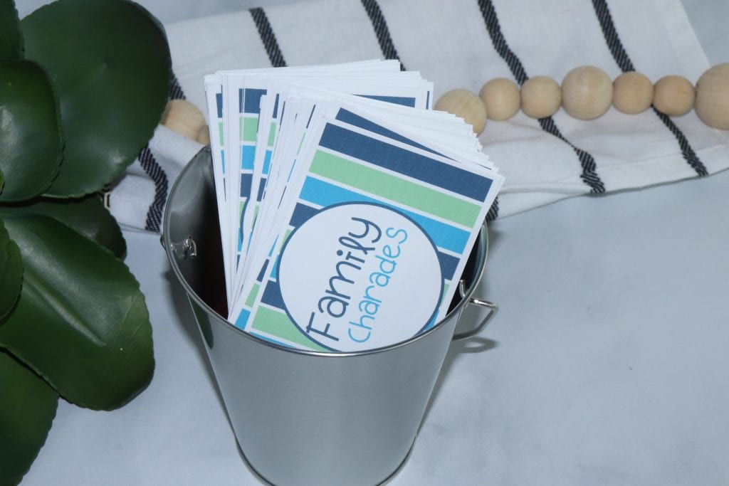 horizontal shot of family charade cards in a metal bucket