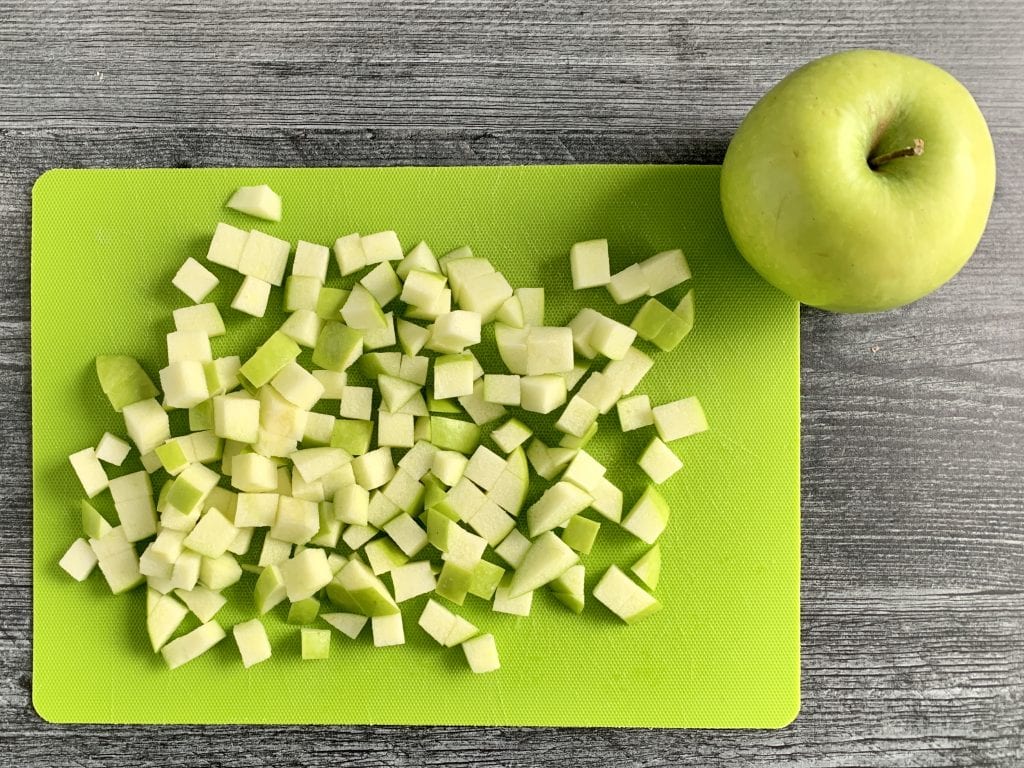 apples cut on a green cutting board