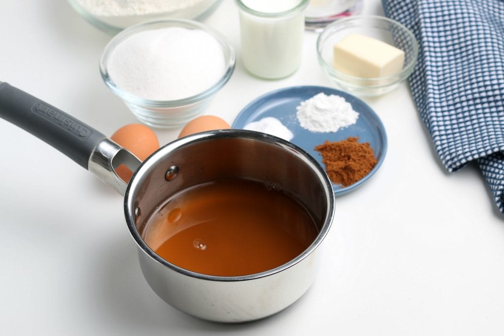apple cider in small saucepan with other ingredients