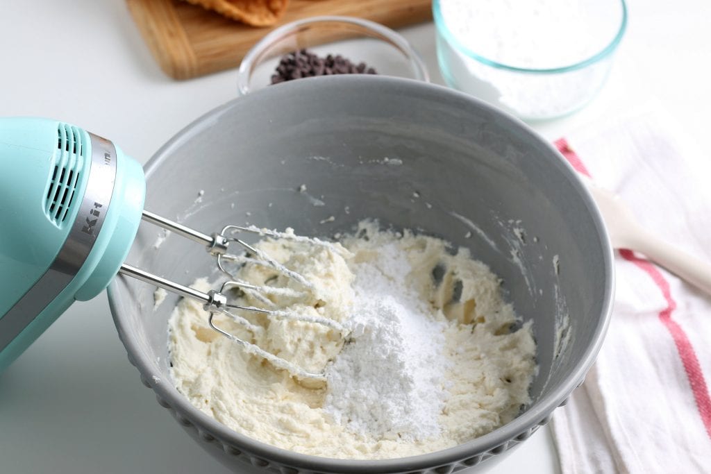 electric mixer in bowl with ingredients