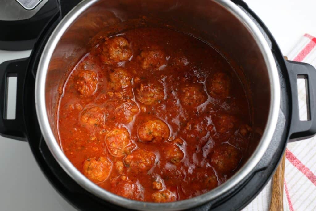 The finished cooked meatballs in the sauce inside the instant pot.