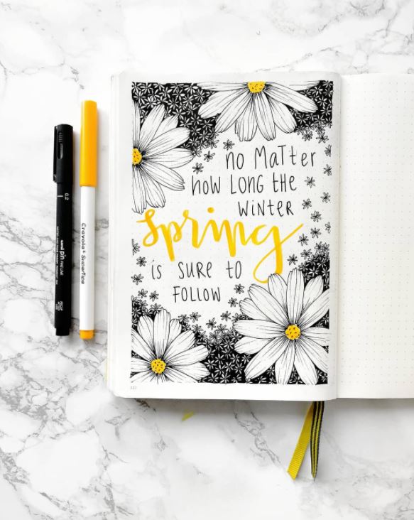 Spring is sure to follow quote with markers on a marble background