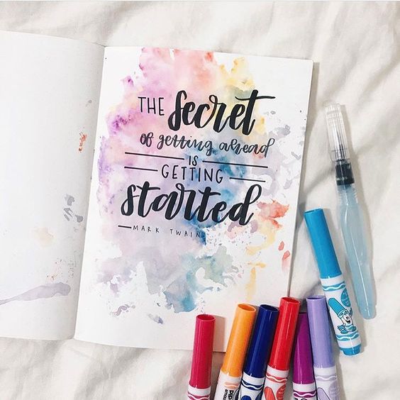 The secret to getting ahead quote with markers on a white background