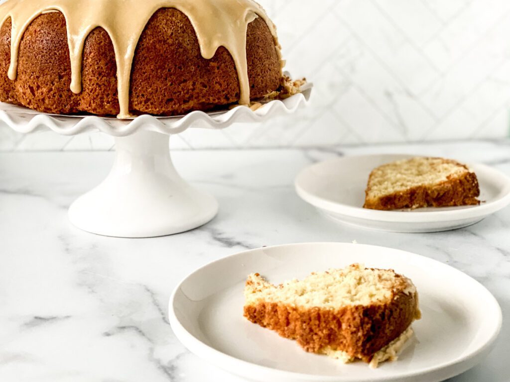 close up of a slice of buttermilk pound cake with caramel icing