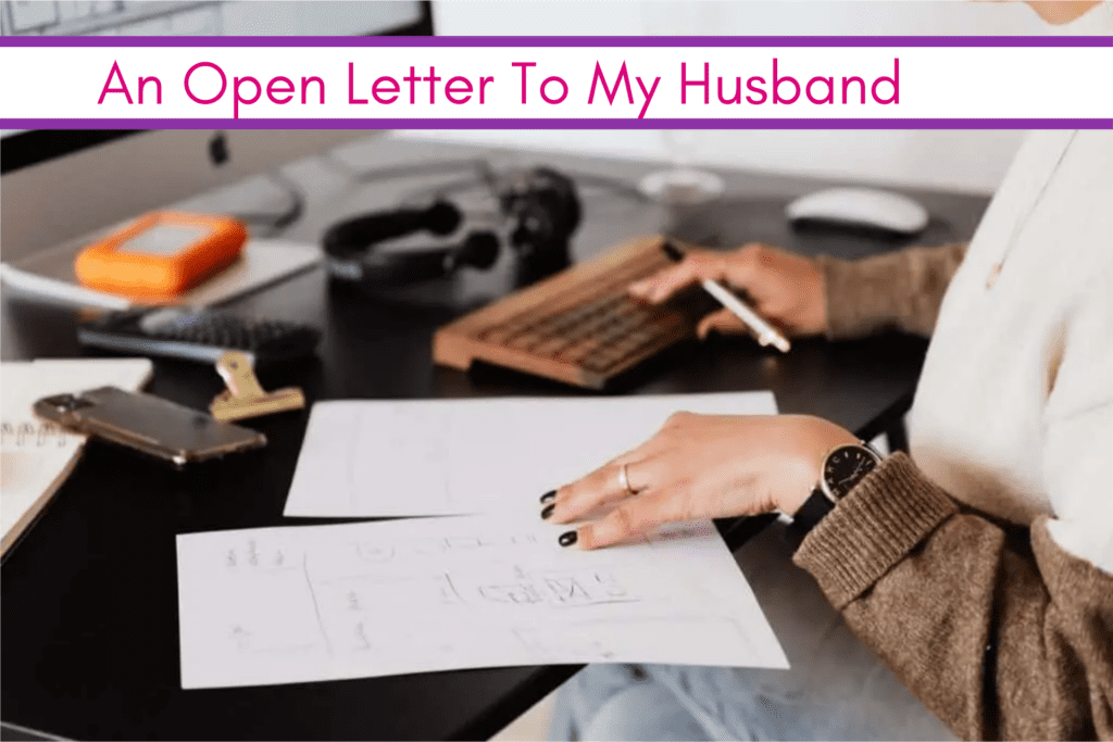 Woman's hands at a desk with two pieces of paper, a pen and a keyboard.