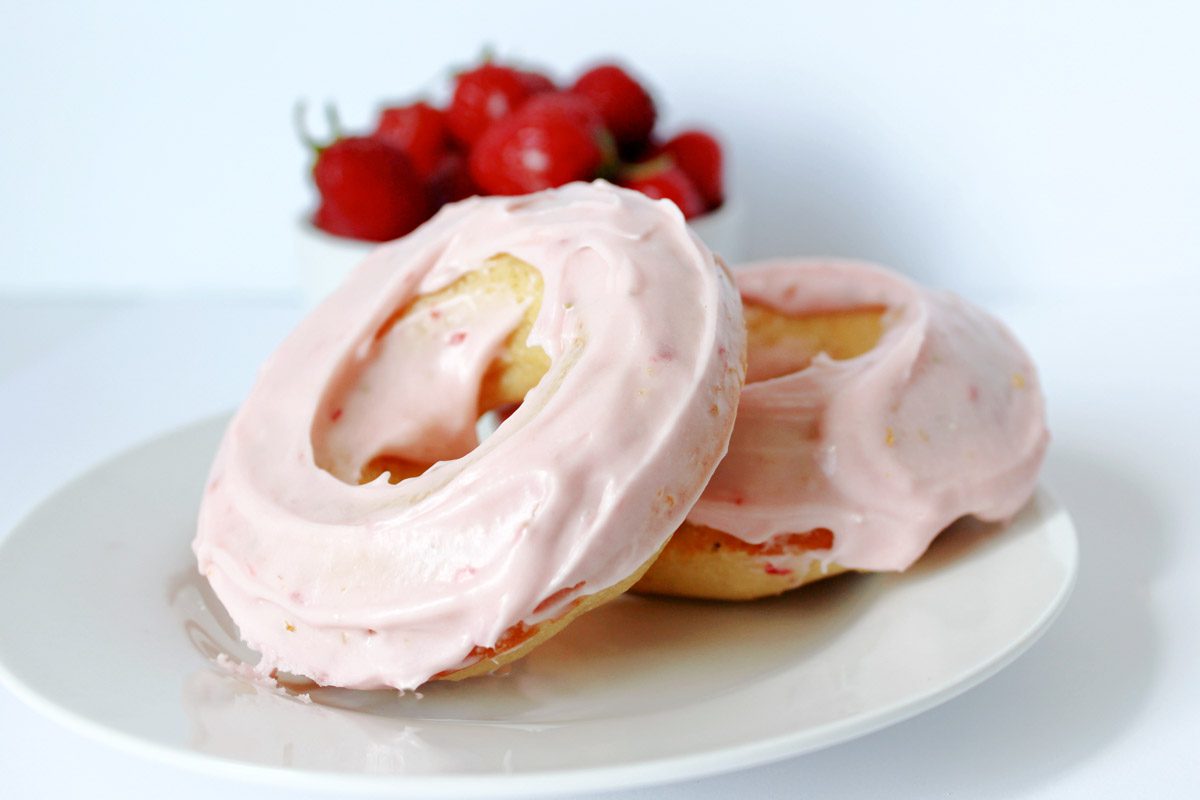 strawberry cream cheese glazed donut on a white plate