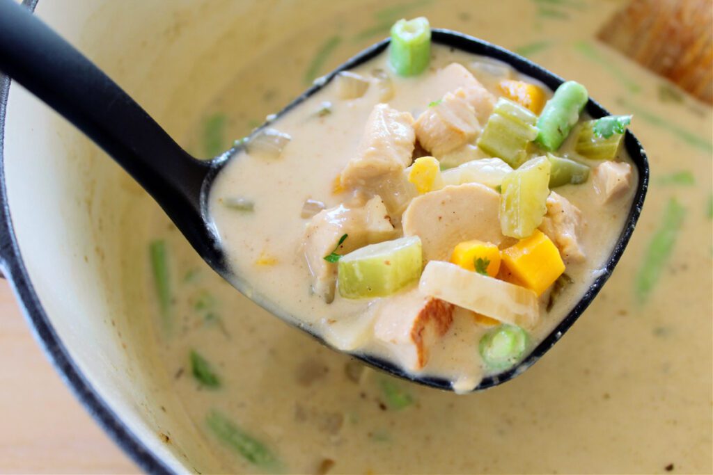 ladle scooping chicken pot pie soup