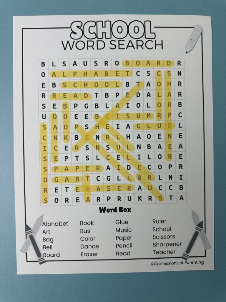 Close-up of a completed school word search puzzle with words highlighted across the page.