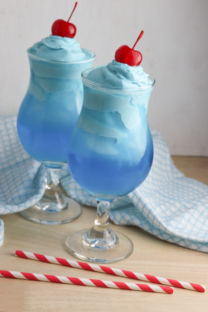 stemmed glasses of whipped kool aid recipe with tea towel and straws