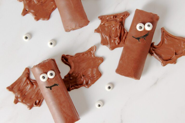 bat bakes sitting on a marble counter with candy eyes