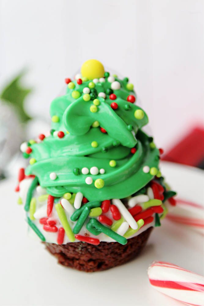 christmas tree brownie bites with candy cane on a cake stand