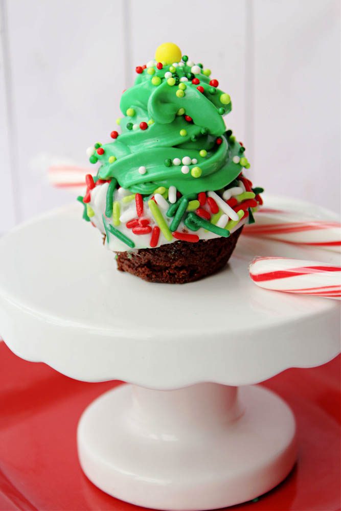 christmas tree brownie bites on a stand with a candy cane