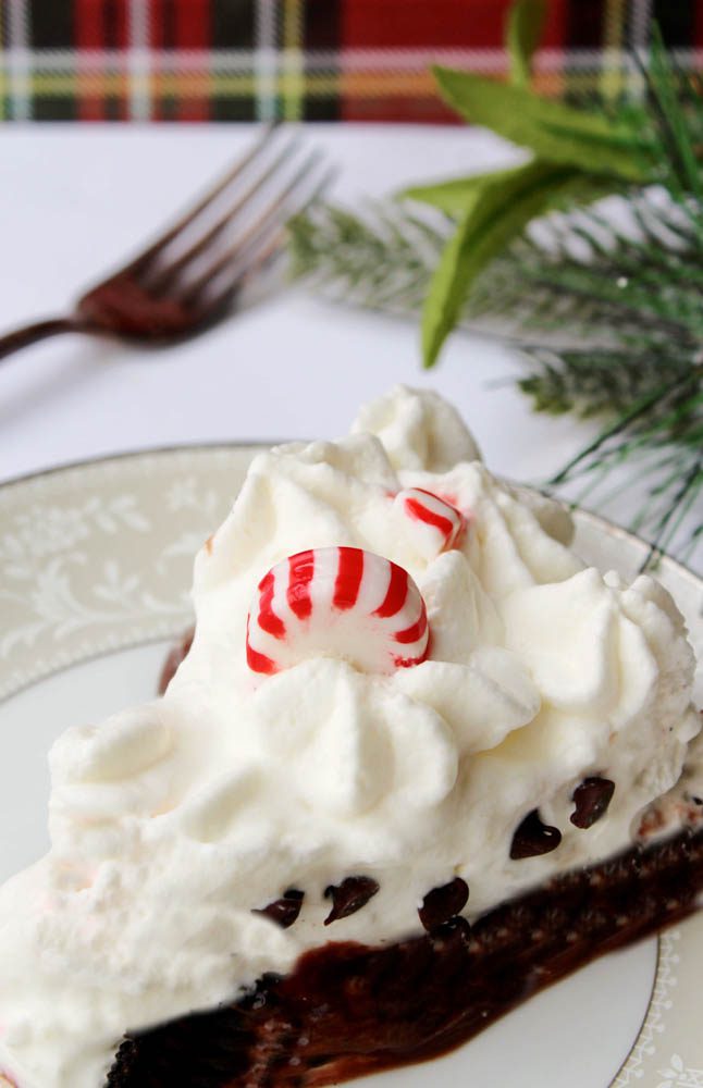 slice of chocolate peppermint pie with holiday greenery