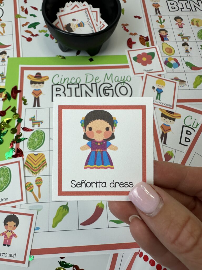 cinco de mayo bingo señorita dress calling card in hand with cinco de mayo bingo game in background