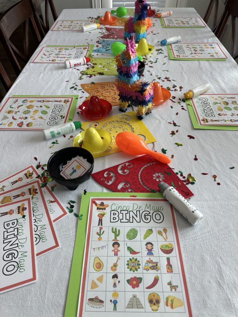 table with Cinco De Mayo decorations and Cinco De Mayo bingo set up on table