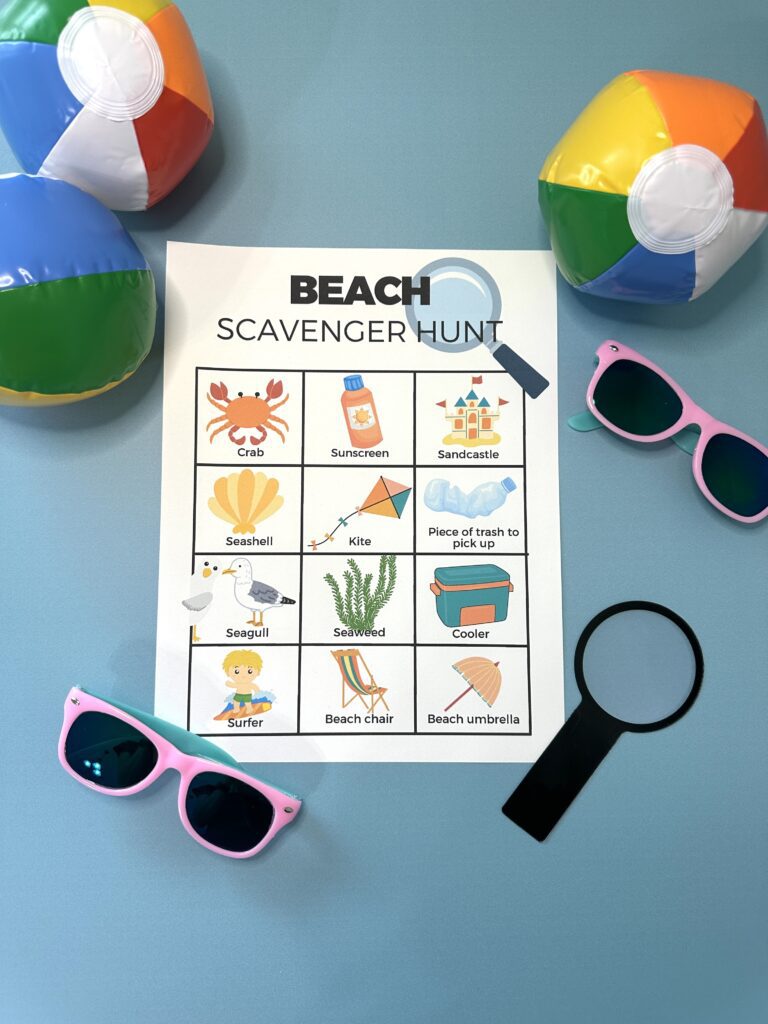 beach scavenger hunt PDF on blue background and beach props
