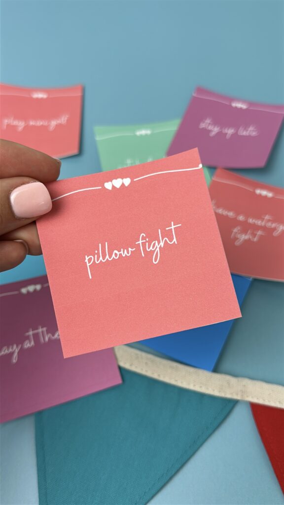 pillow fight pink summer bucket list card with lea background and other summer bucket list cards in the background
