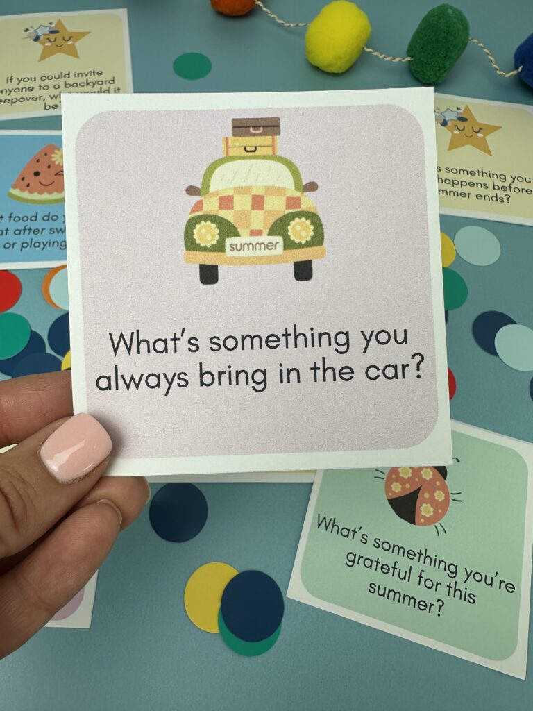 closeup of road trip summer conversation starters card with blue background in the background