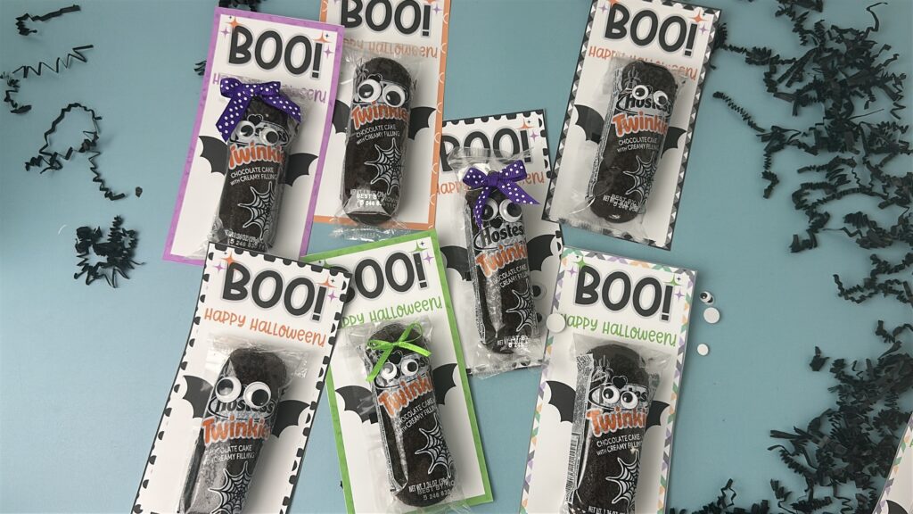 Assorted Halloween snack cake bats wrapped with googly eyes and bows, each on printable “BOO! Happy Halloween” cards.