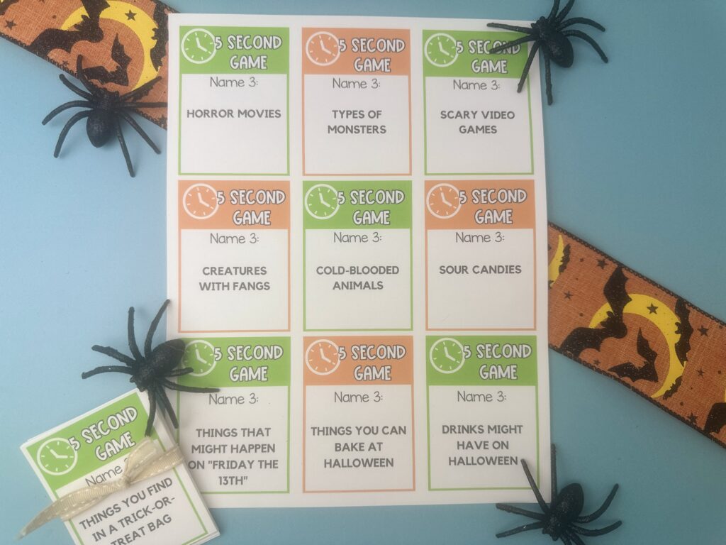 Printable Halloween 5 Second Game cards with spooky prompts and spider decorations on a blue background.