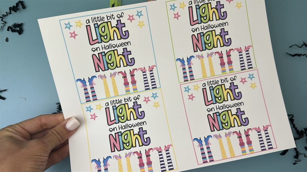 Sheet of four printable “A little bit of light on Halloween night” tags ready to cut.