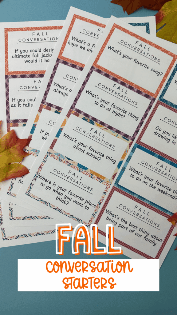 Printable fall conversation starter cards laid out on a blue background with autumn leaves. The cards feature colorful borders and prompts like “What’s your favorite song?” and “If you could design the ultimate fall jacket, what would it have?” The text overlay reads “Fall Conversation Starters.”