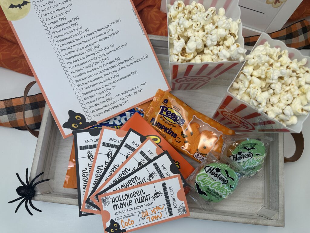 Stack of Halloween movie night tickets with Peeps pumpkins and Hostess cupcakes.