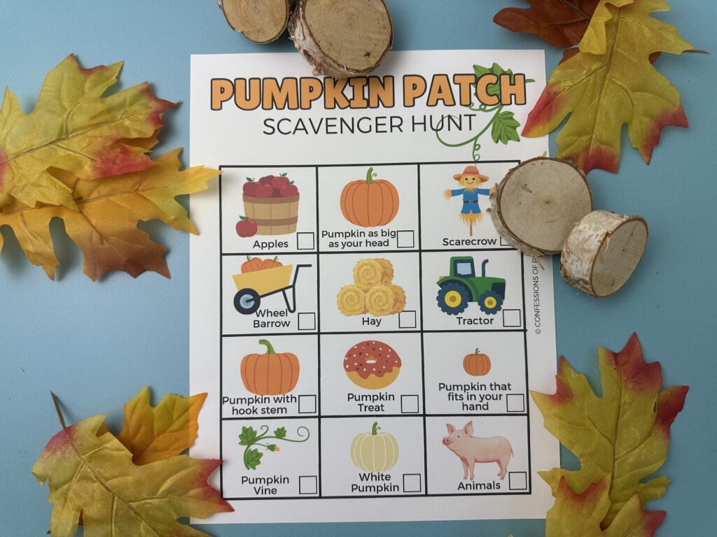 Pumpkin Patch Scavenger Hunt printable on a blue background surrounded by colorful fall leaves and wooden slices.