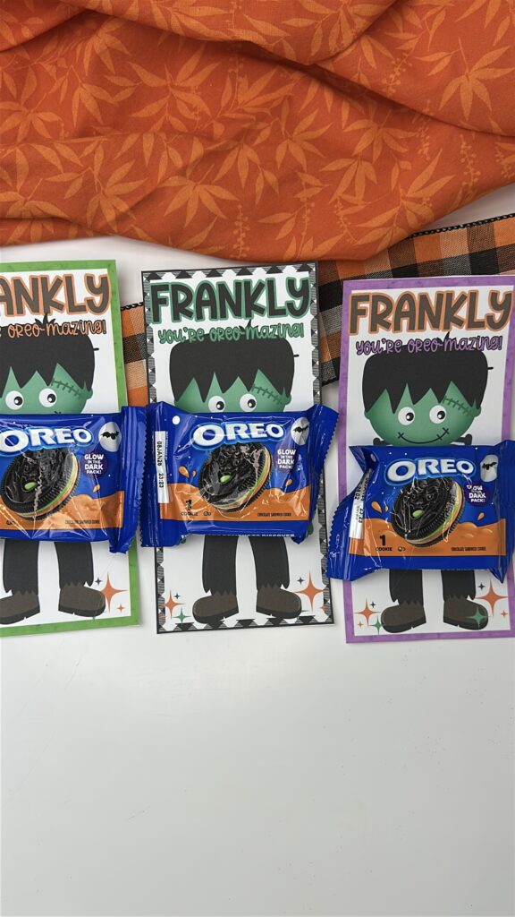Three Frankenstein Oreo treat printables in green, black, and purple borders laid out with orange fabric and plaid ribbon.