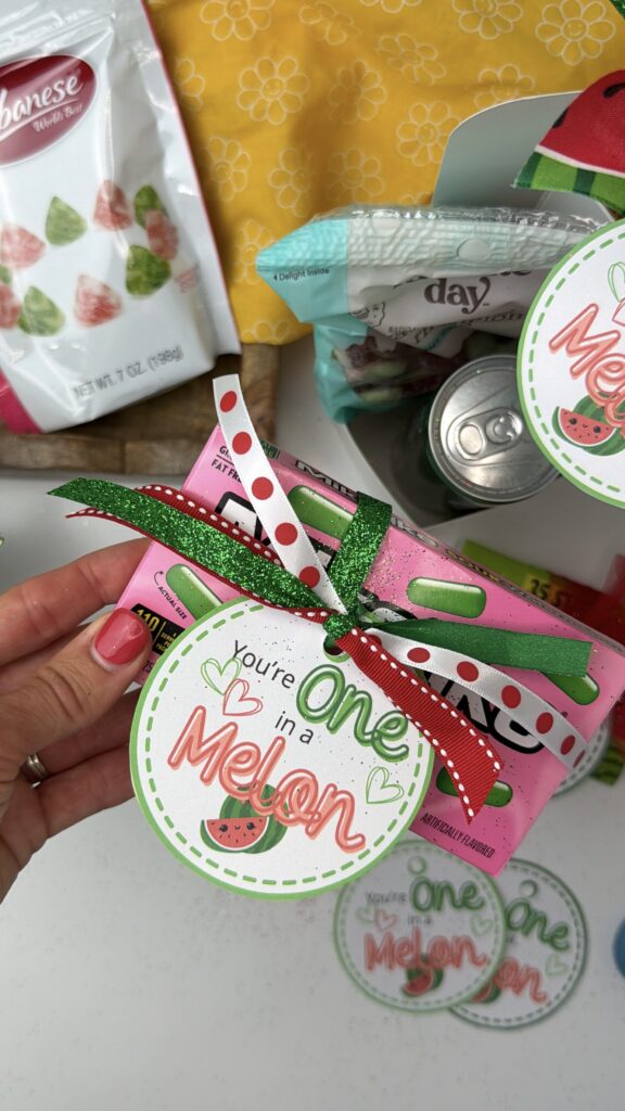 You’re one in a melon gift tag tied with ribbon on a candy box for a simple watermelon themed gift
