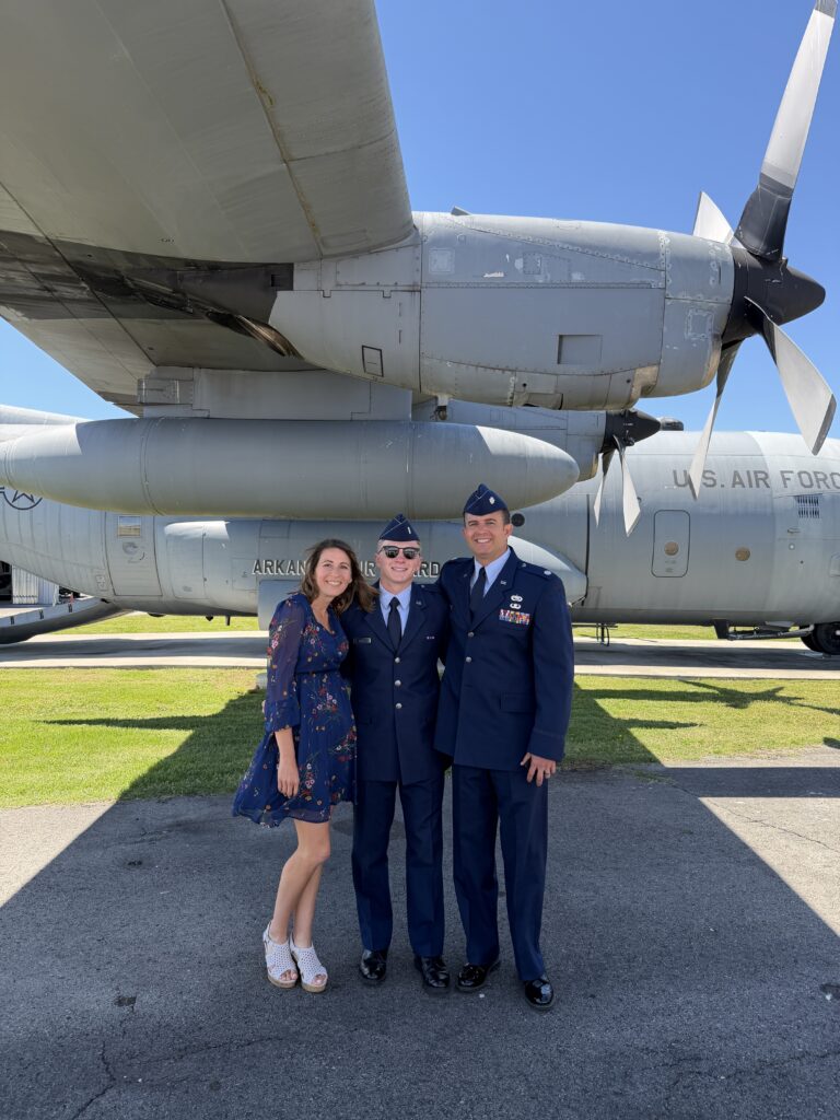 Michele Tripple and husband and son in front of USAF plane 